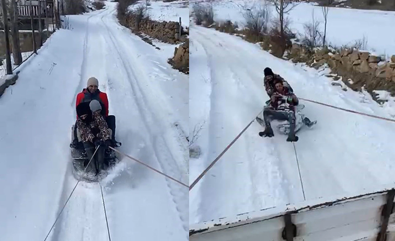 Kamyonet arkasına bağladıkları tekerlekle karda kaymanın keyfini yaşadılar